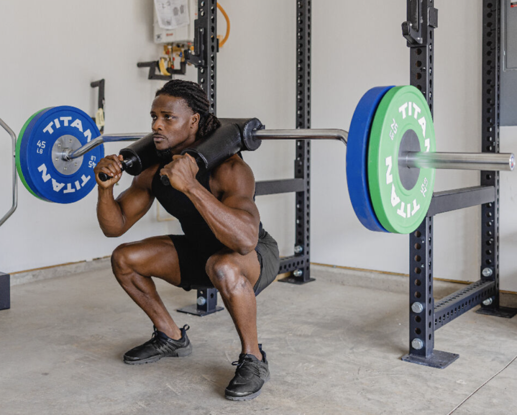 man perfoming squats with a safety squat bar
