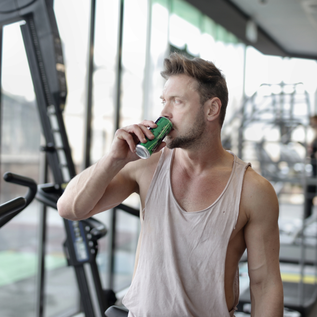 man at the gym drinking an energy drink