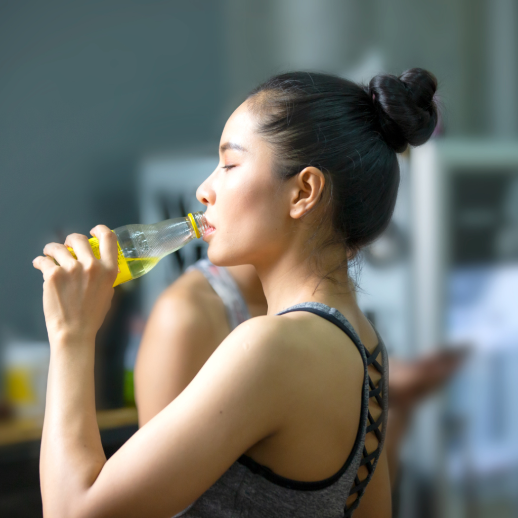 woman drinking an energy drink from a bottle- is zero sugar monster good for you?